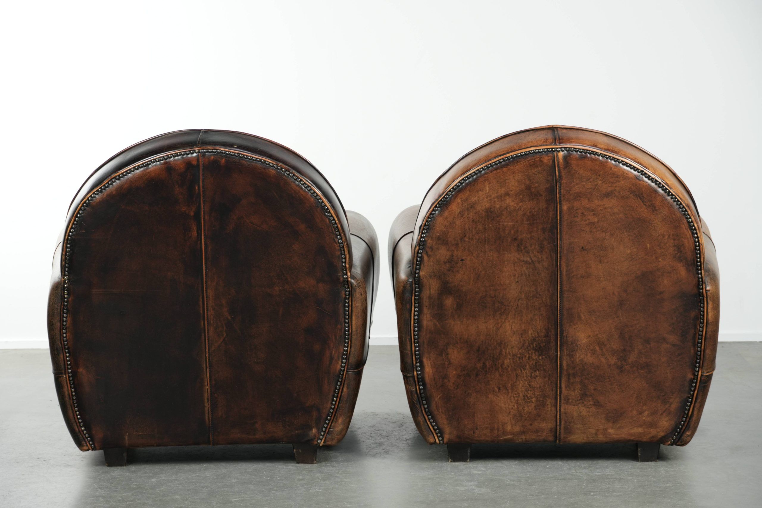 Set of two sheepskin Art Deco design armchairs with beautiful patina