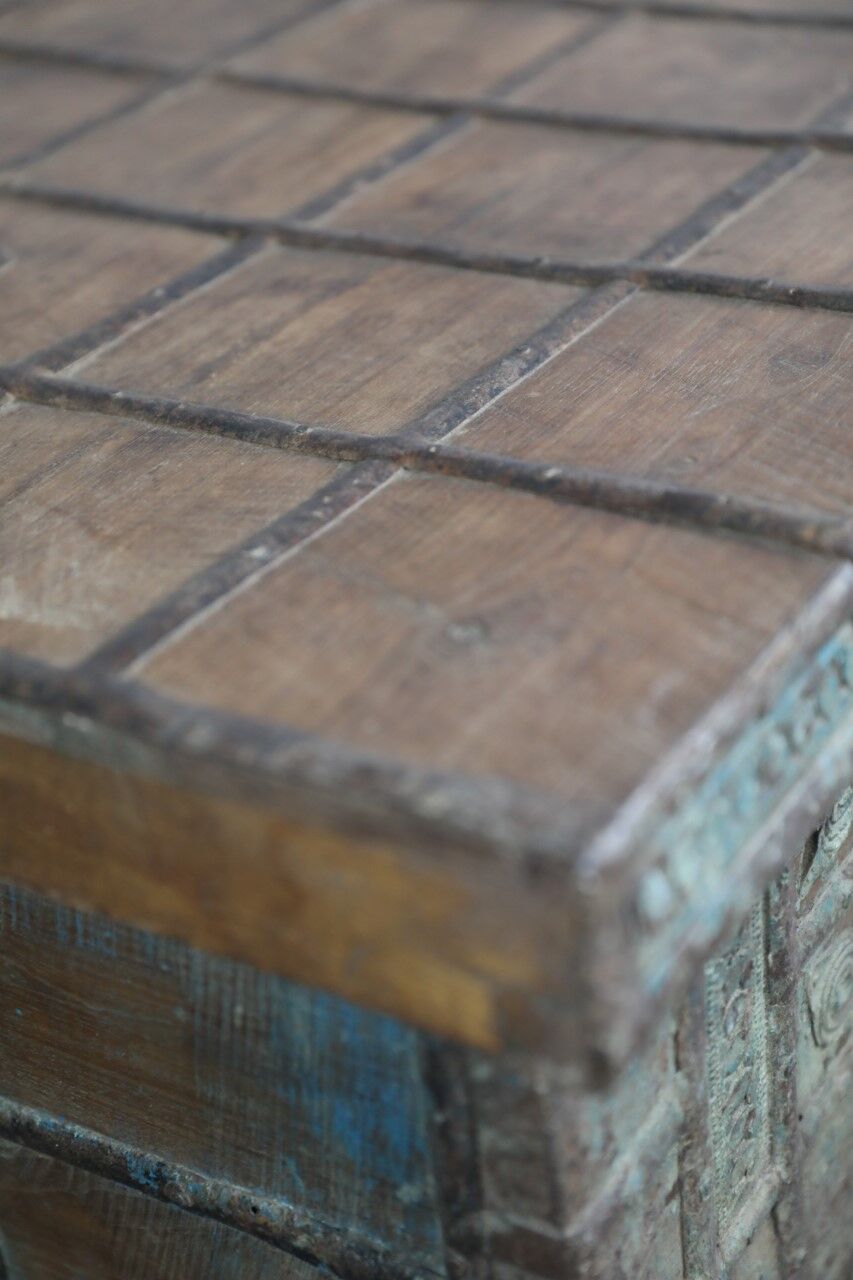 Low chest with metal closure and top opening.