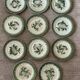 11 old dessert plates from the Pexonne earthenware factory, green and cream fruit decoration