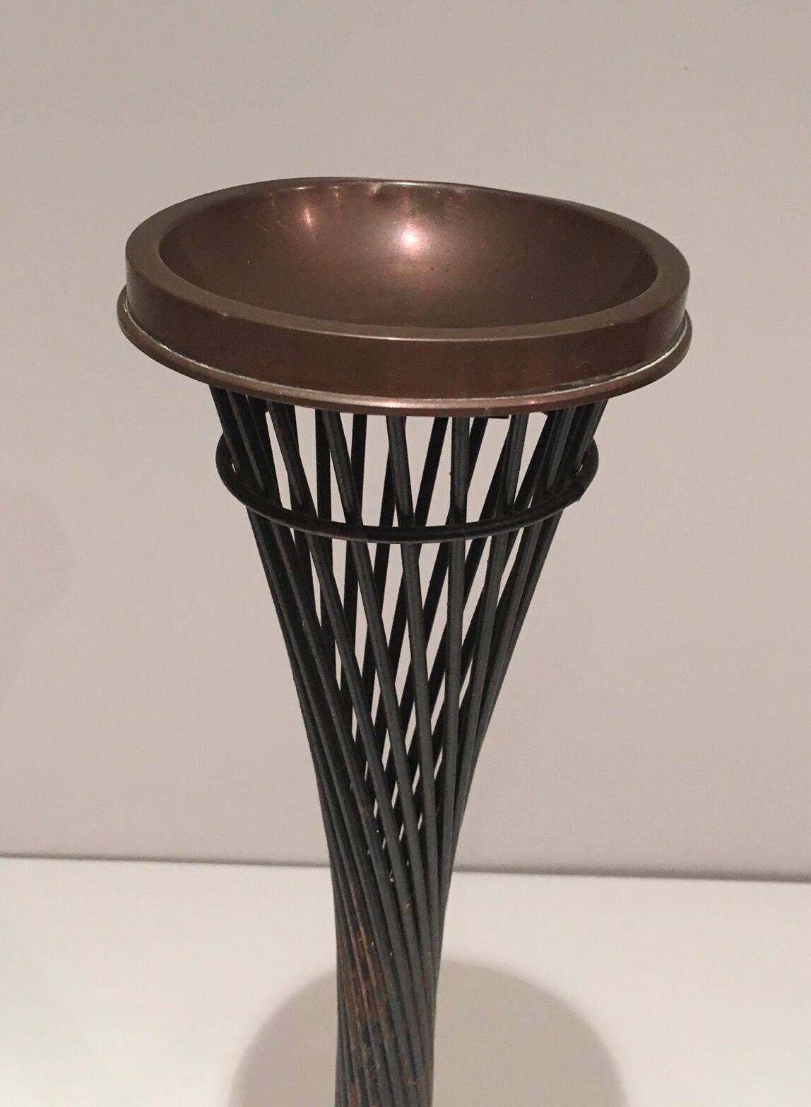 Brass ashtray on a stand made of black lacquered metal wire.