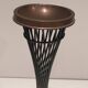 Brass ashtray on a stand made of black lacquered metal wire.
