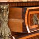 Tomb-shaped commode in Louis XV style with decoration featuring Spanish figures.