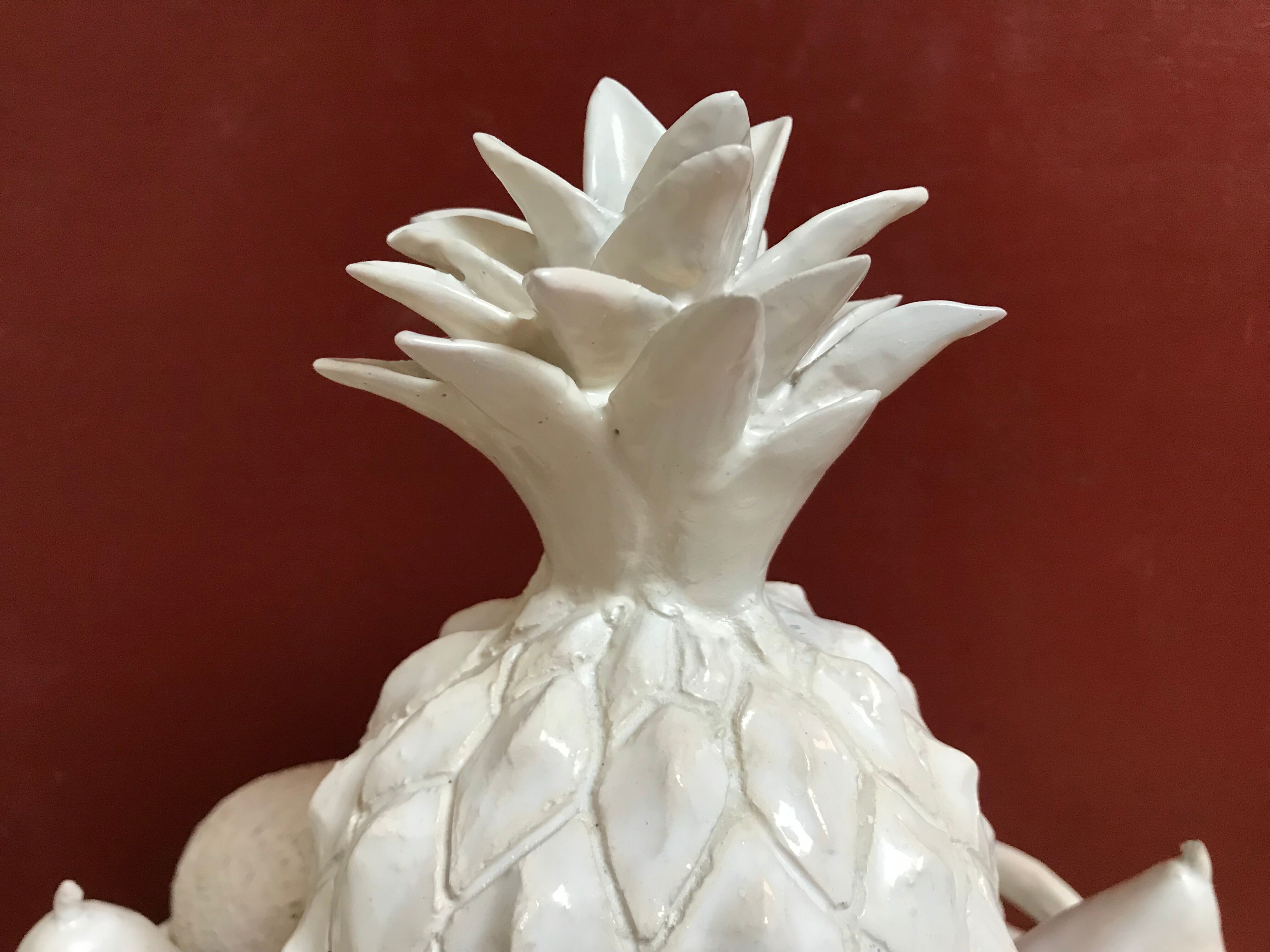 Trompe l'oeil fruit cut in white earthenware by Jean Roger, circa 1960.