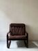 Scandinavian armchair with turned wood and brown patchwork leather, 70s design.
