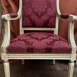 Louis XVI style armchair in patinated wood and damask fabric