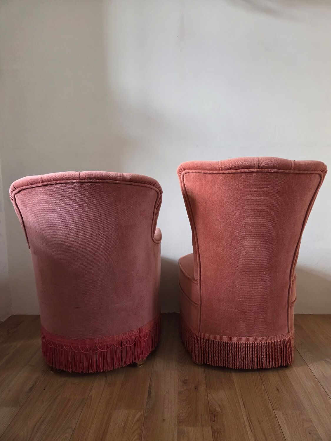 A pair of small tub chairs.