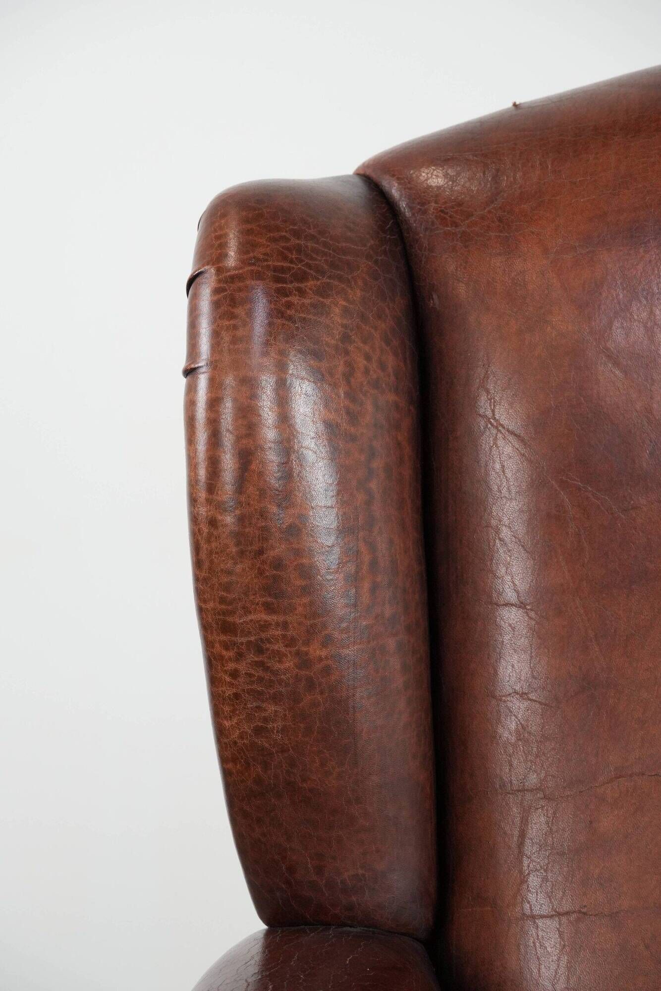 Classic vintage wingback chair in sheepskin and wood