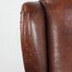Classic vintage wingback chair in sheepskin and wood