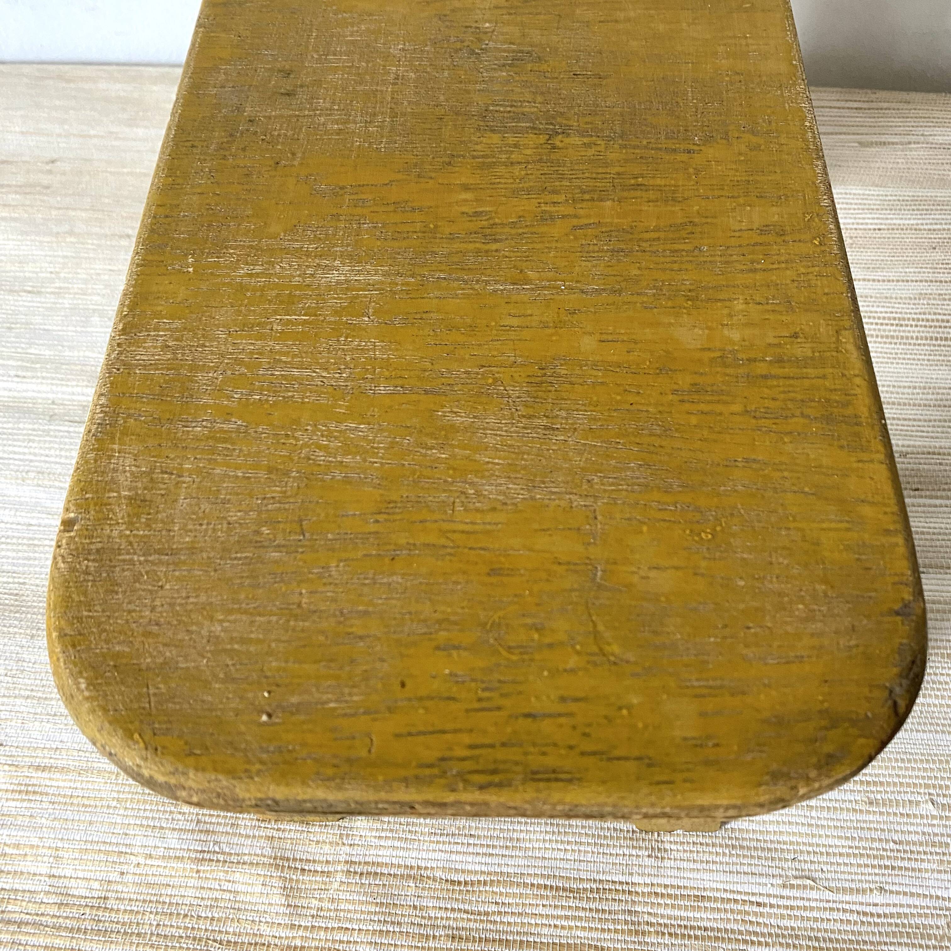 Low stool, plant stand in yellow painted wood