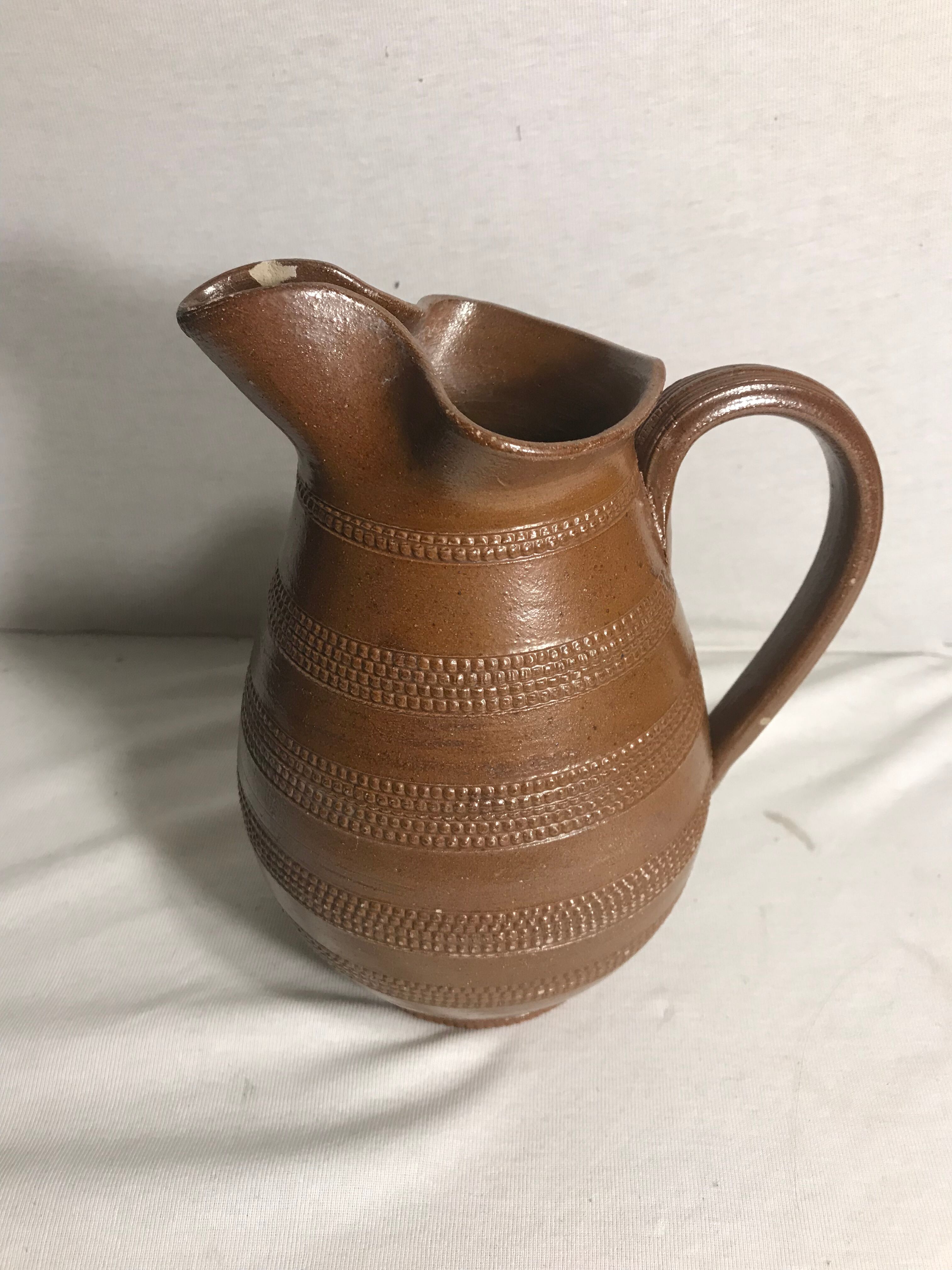 Old brown glazed ceramic jug from the 1950s