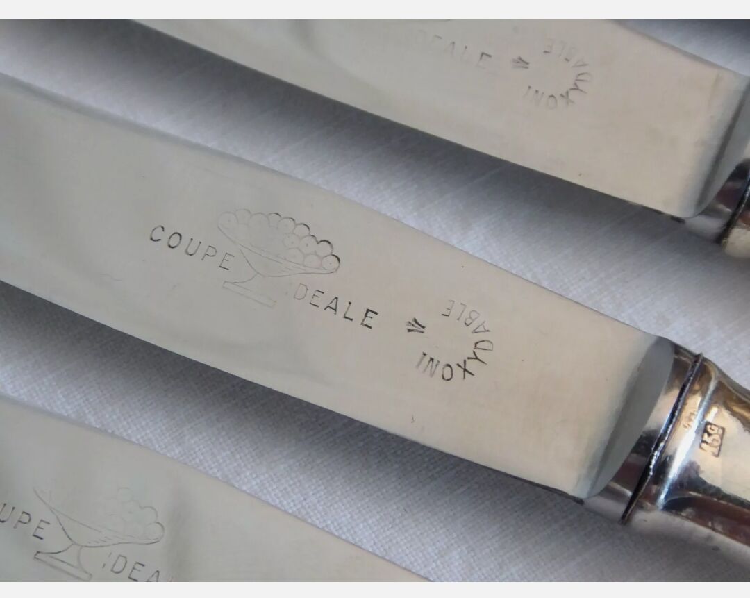 12 silver metal knives