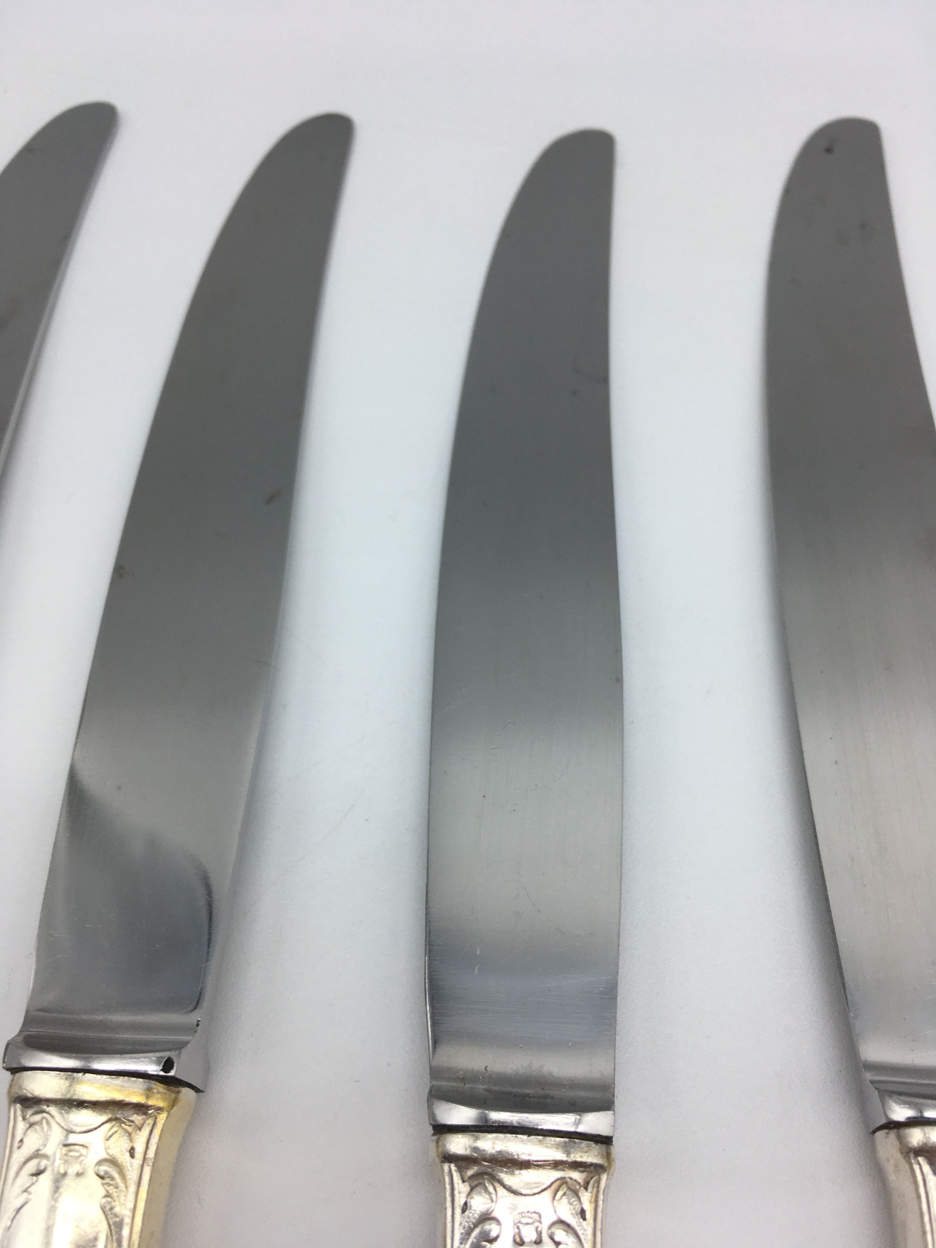 12 silver metal knives.