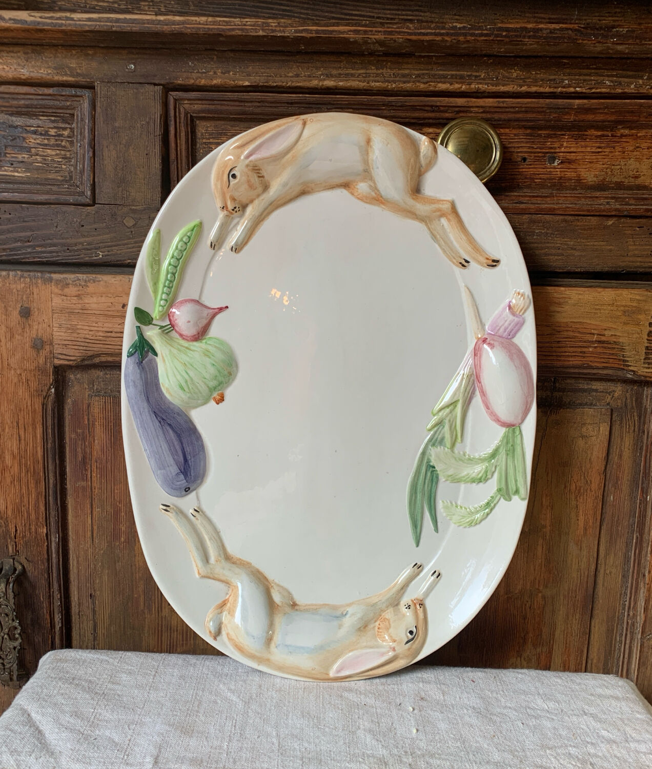 Very large serving dish with hares and vegetables.
