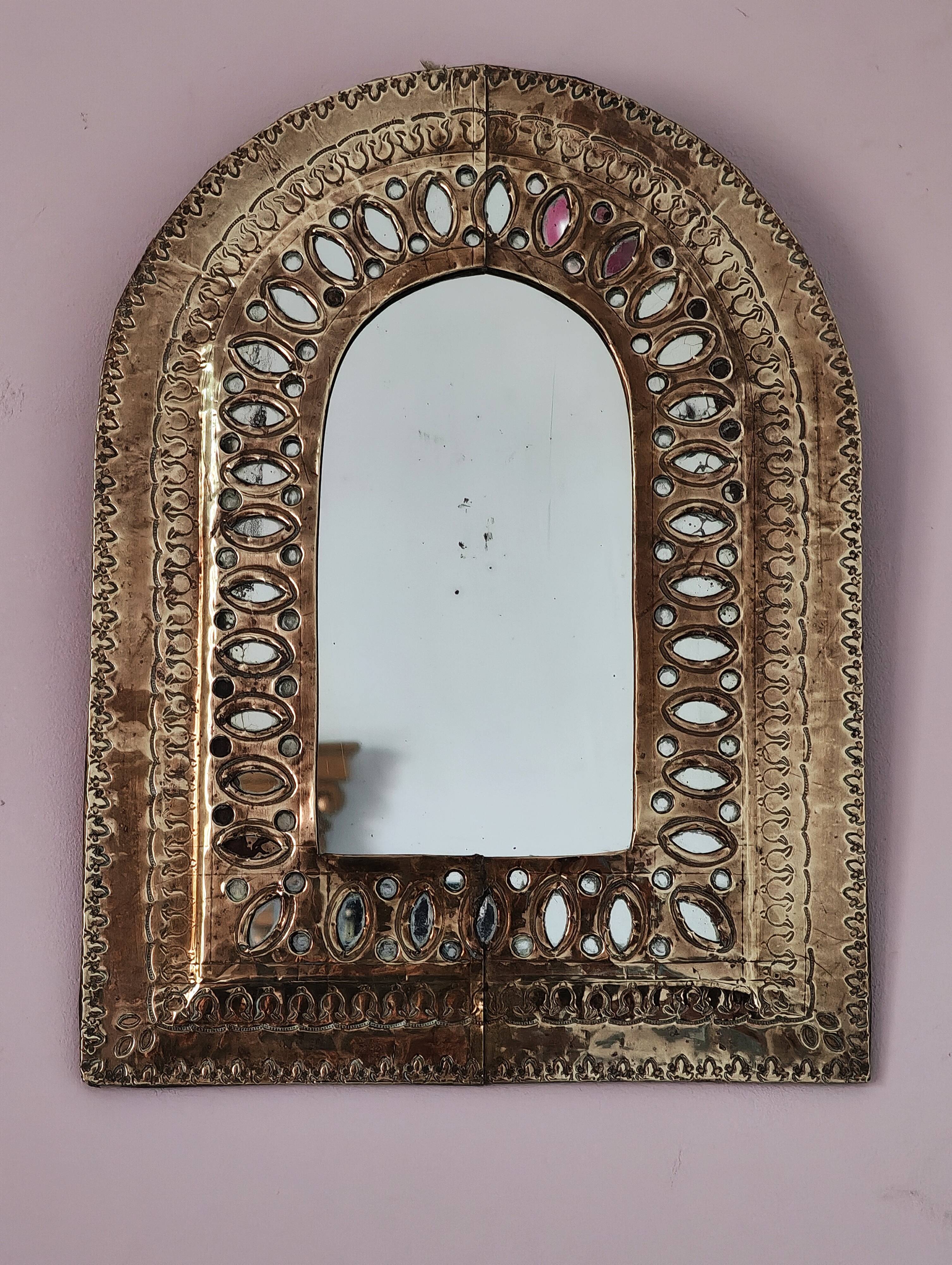 Small golden metal mirror in oriental style.