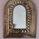 Small golden metal mirror in oriental style.