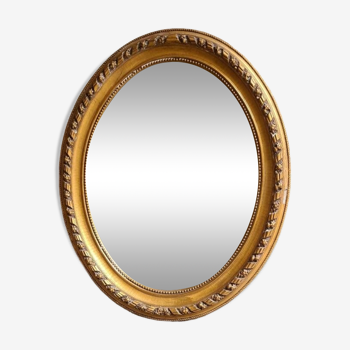 Miroir ovale, style Louis XVI, en bois doré