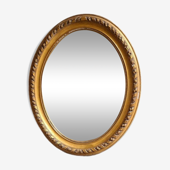 Oval mirror, Louis XVI style, in gilded wood