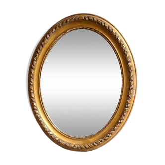 Oval mirror, Louis XVI style, in gilded wood