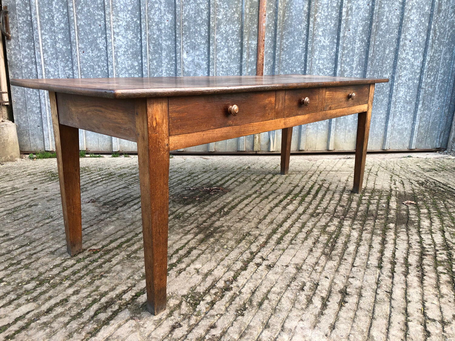 Antique chestnut farmhouse table with 3 drawers on the front.
