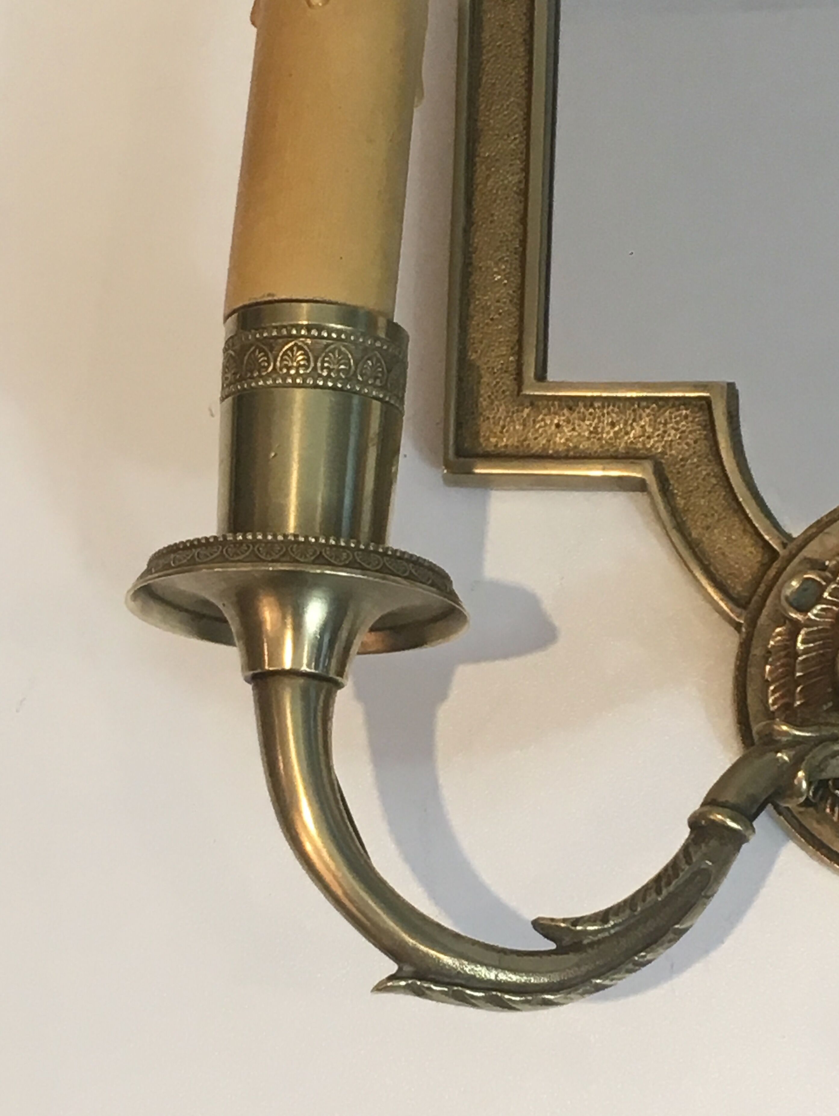 Pair of mirror and bronze wall lamps with lions' heads, french work. around 1940