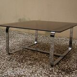 Table basse Roche Bobois 1970 verre fumé piètement en métal chromé.