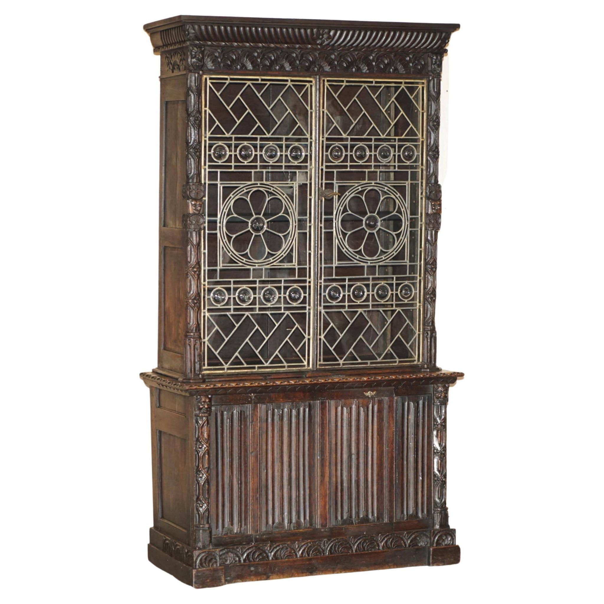 Jacobean hardwood library with carved panels and glass doors.