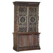 Jacobean hardwood library with carved panels and glass doors.