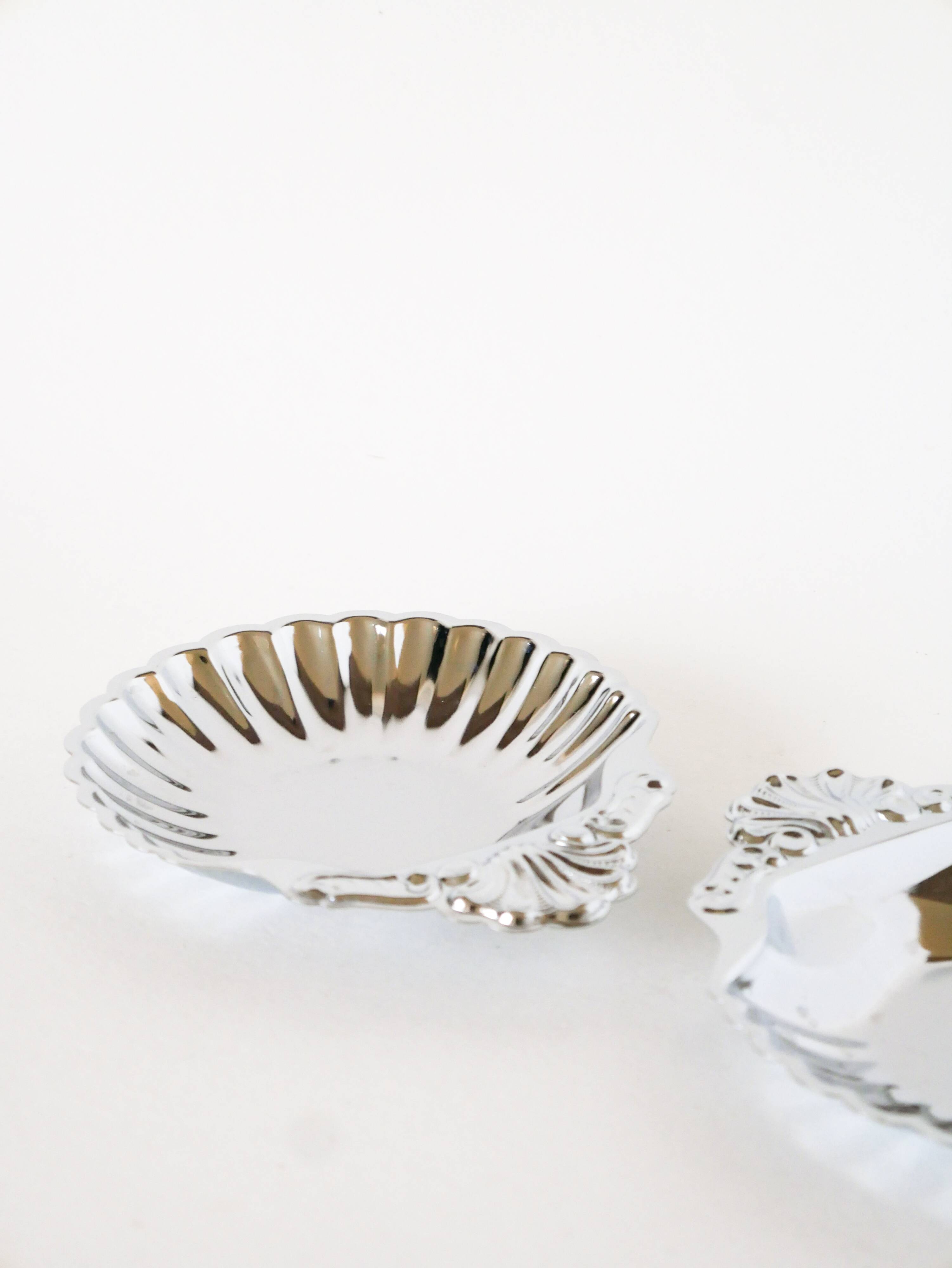 Pair of worked stainless steel shell trinket trays, 1970