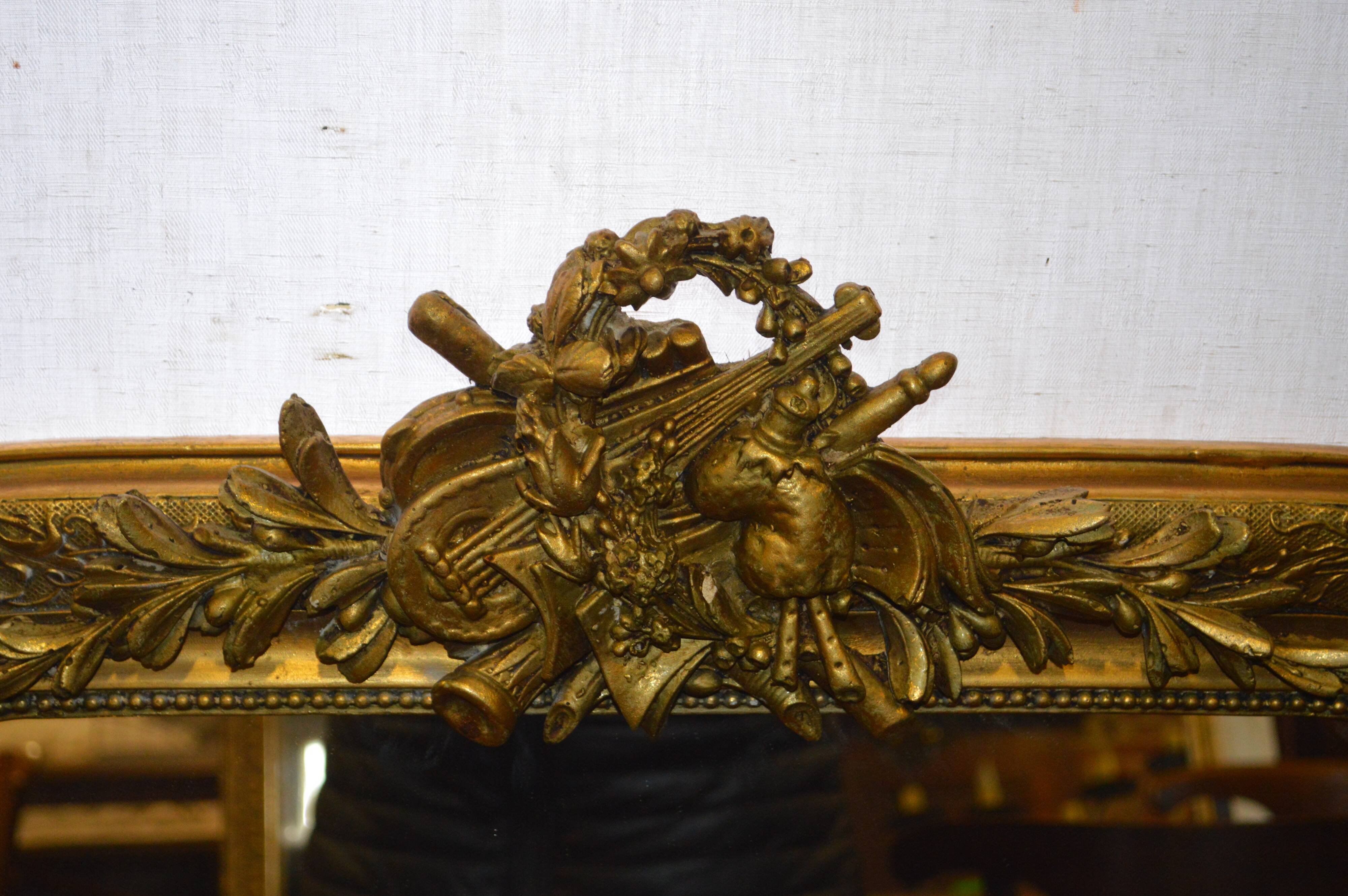 Mirror gilded with musical instruments 75x116cm