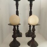 Two pairs of patinated brass candle holders