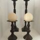 Two pairs of patinated brass candle holders