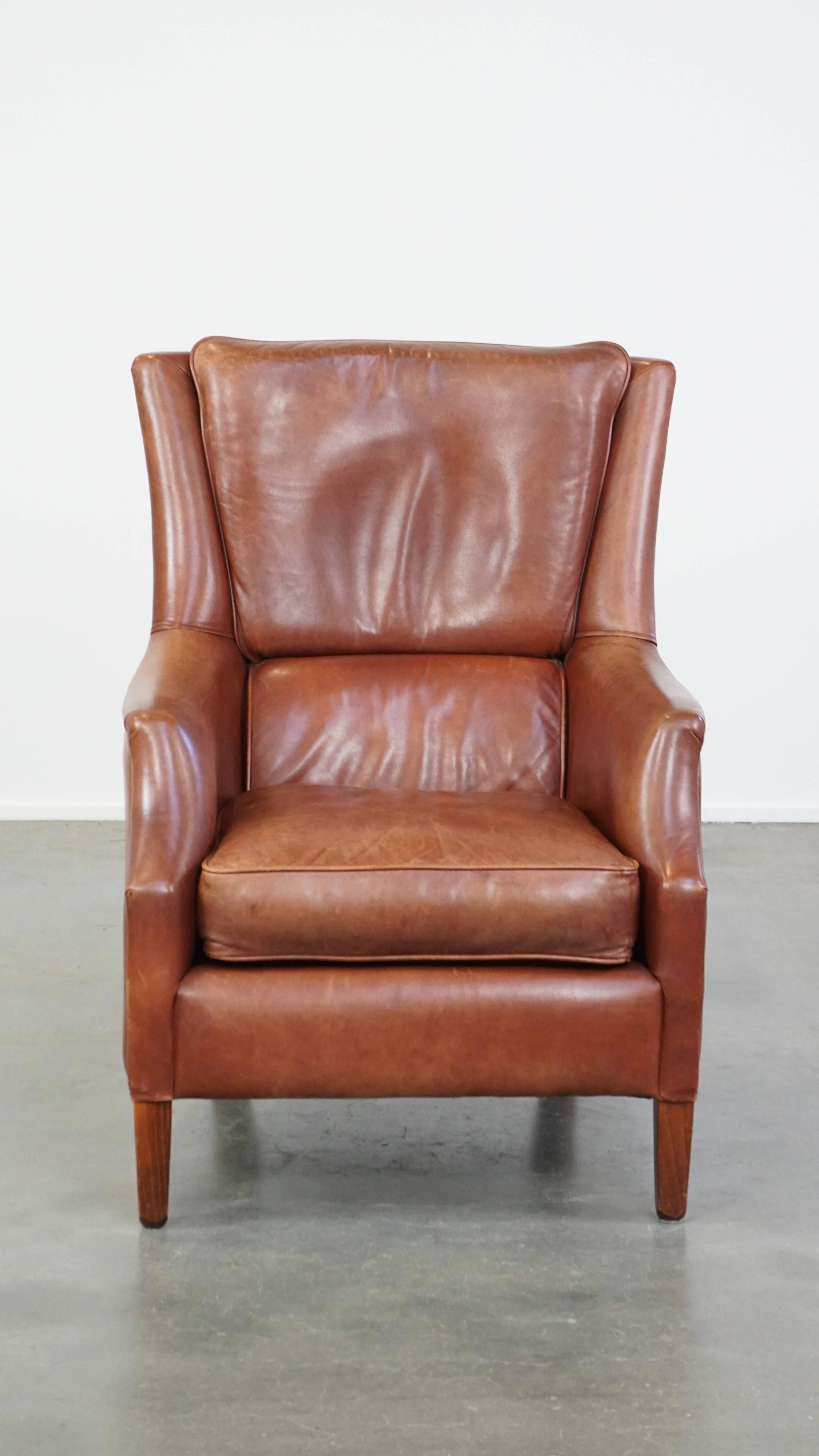 Cowhide armchair in good condition, finished with decorative nails