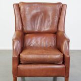 Cowhide armchair in good condition, finished with decorative nails