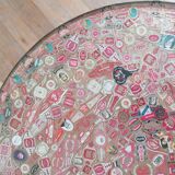 Small side table decorated with cigar rings under beveled glass
