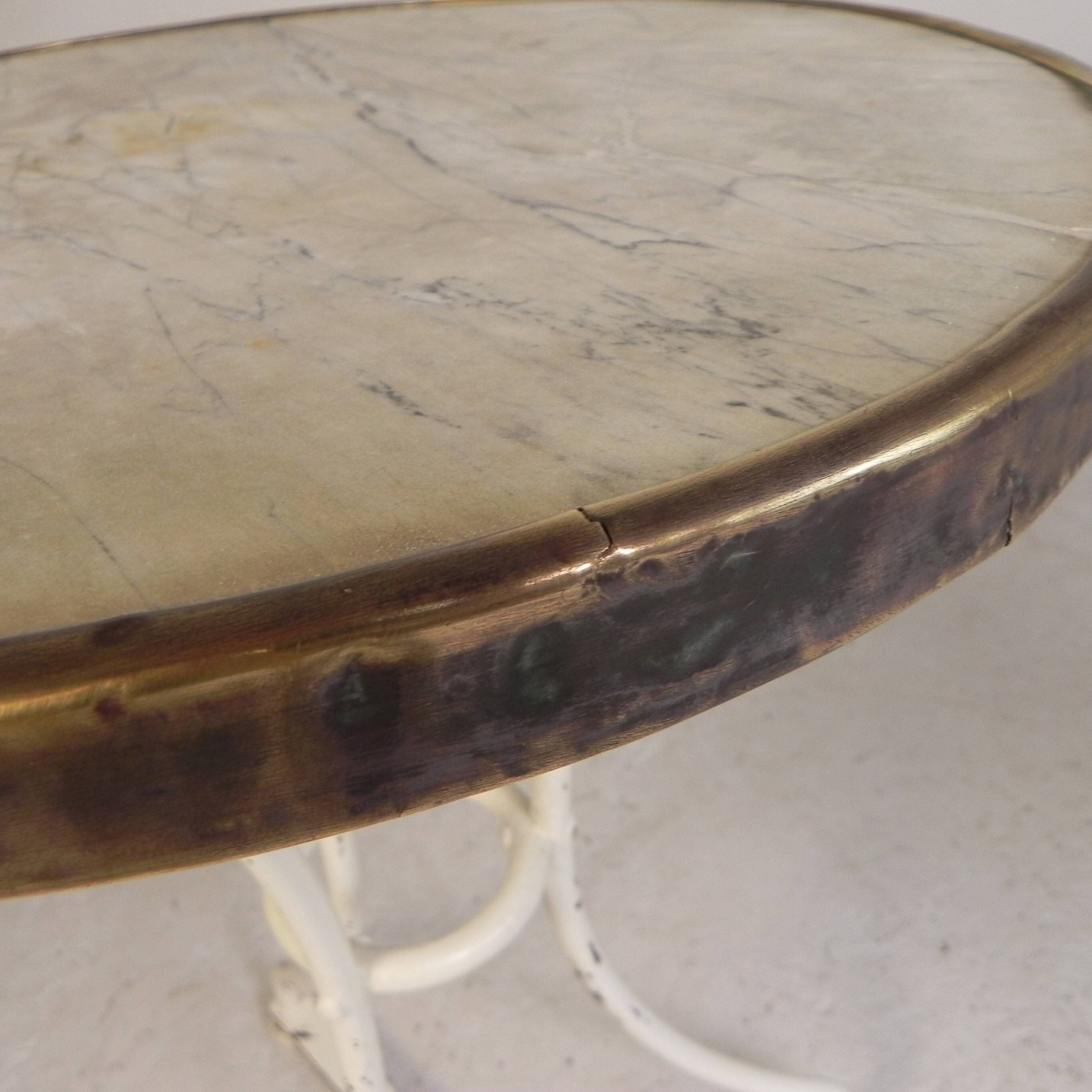 Bistro table with a marble top and brass edging, early 20th century.