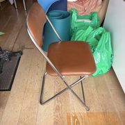 Brown folding chair in vinyl and steel