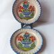 Pair of antique plates in popular earthenware with a floral basket decoration on the edge.