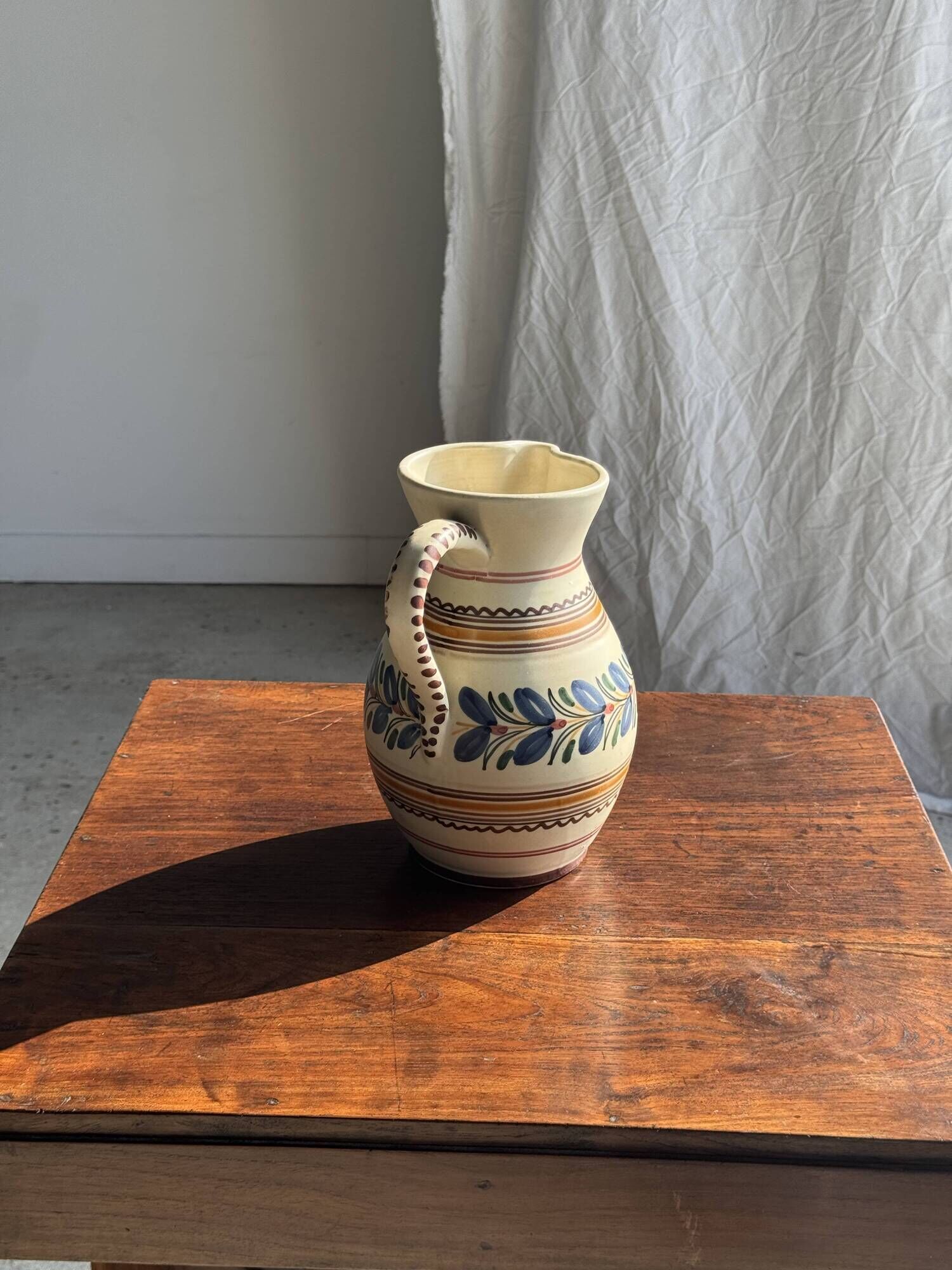 Beige carafe with stylized blue flower friezes