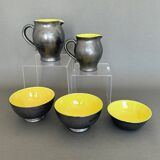 Two pitchers and three Elchinger ceramic bowls black and yellow background 1960