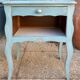 Pair of patinated lagoon blue bedside tables, early 20th century, with curved legs.
