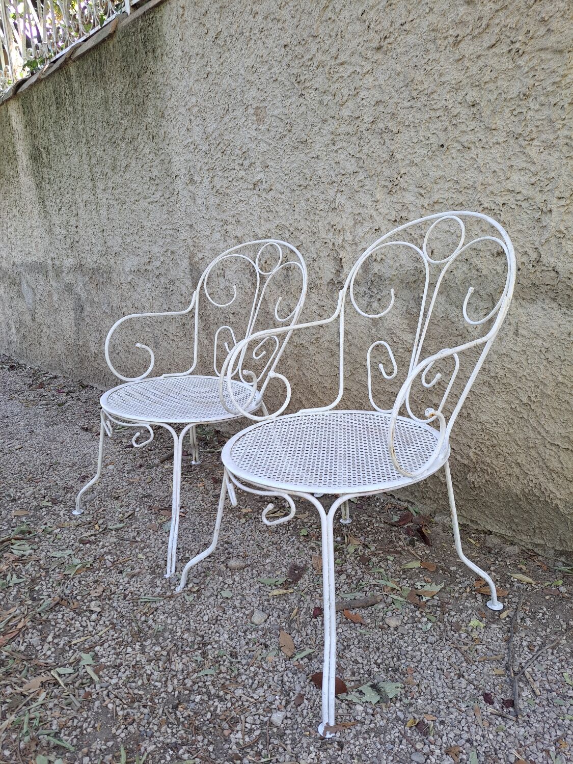 Pair of old white iron armchairs