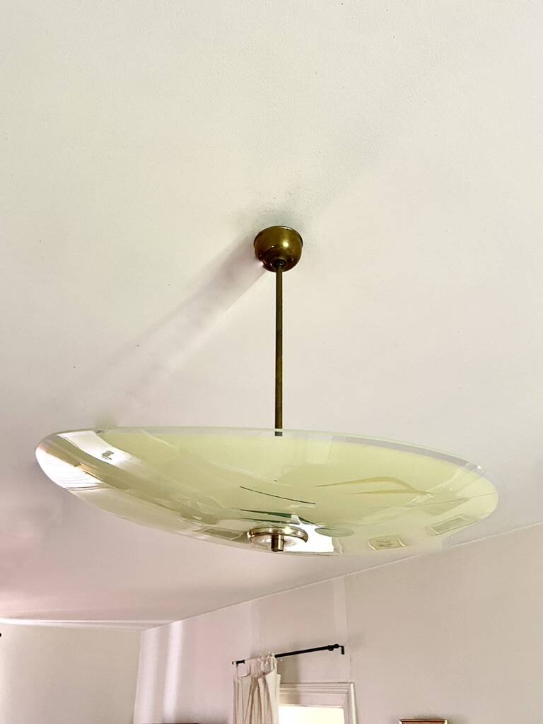 Pale yellow asymmetrical suspension cup 1960