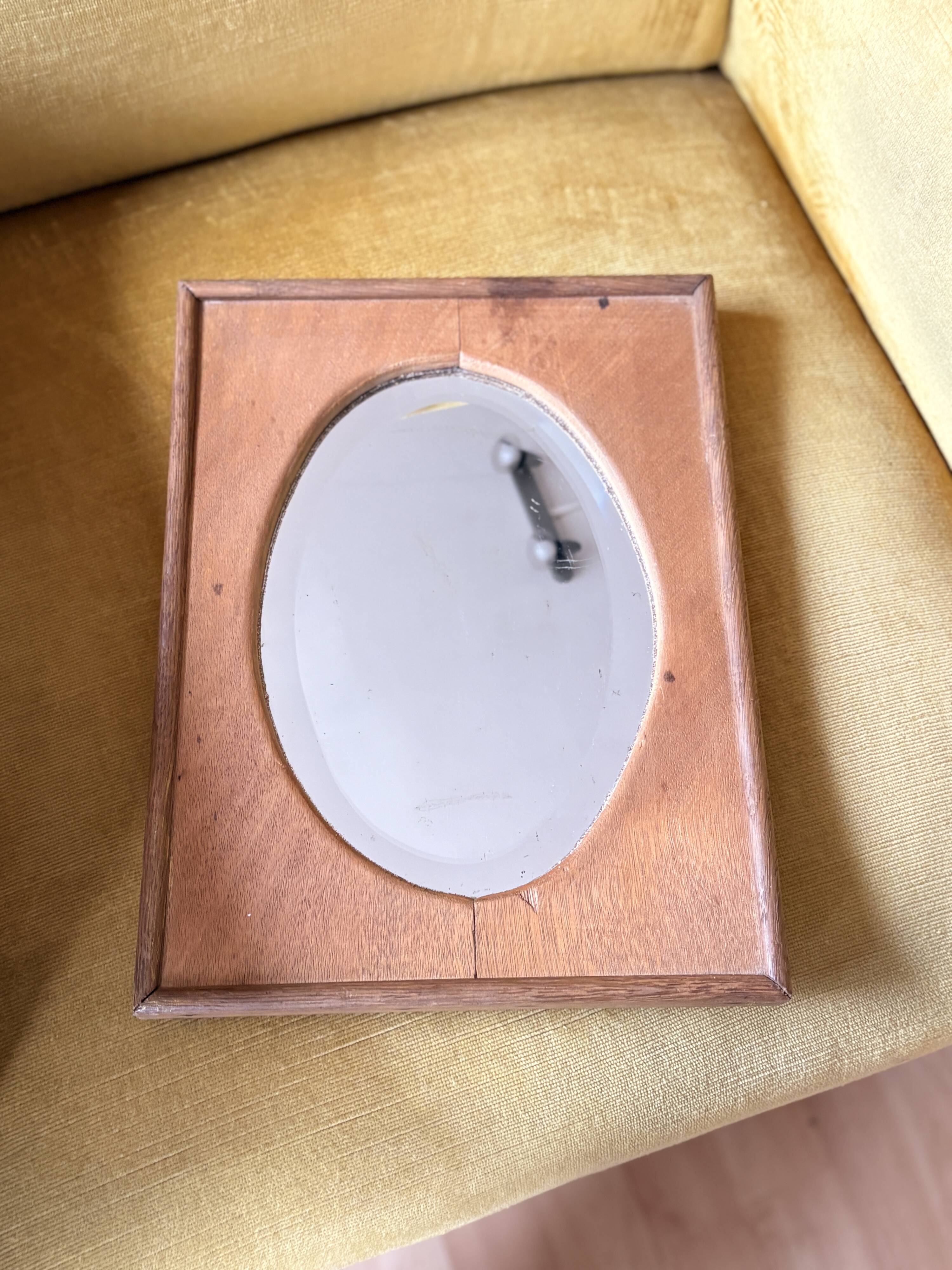 Bevelled oval mirror on oak frame