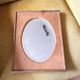 Bevelled oval mirror on oak frame