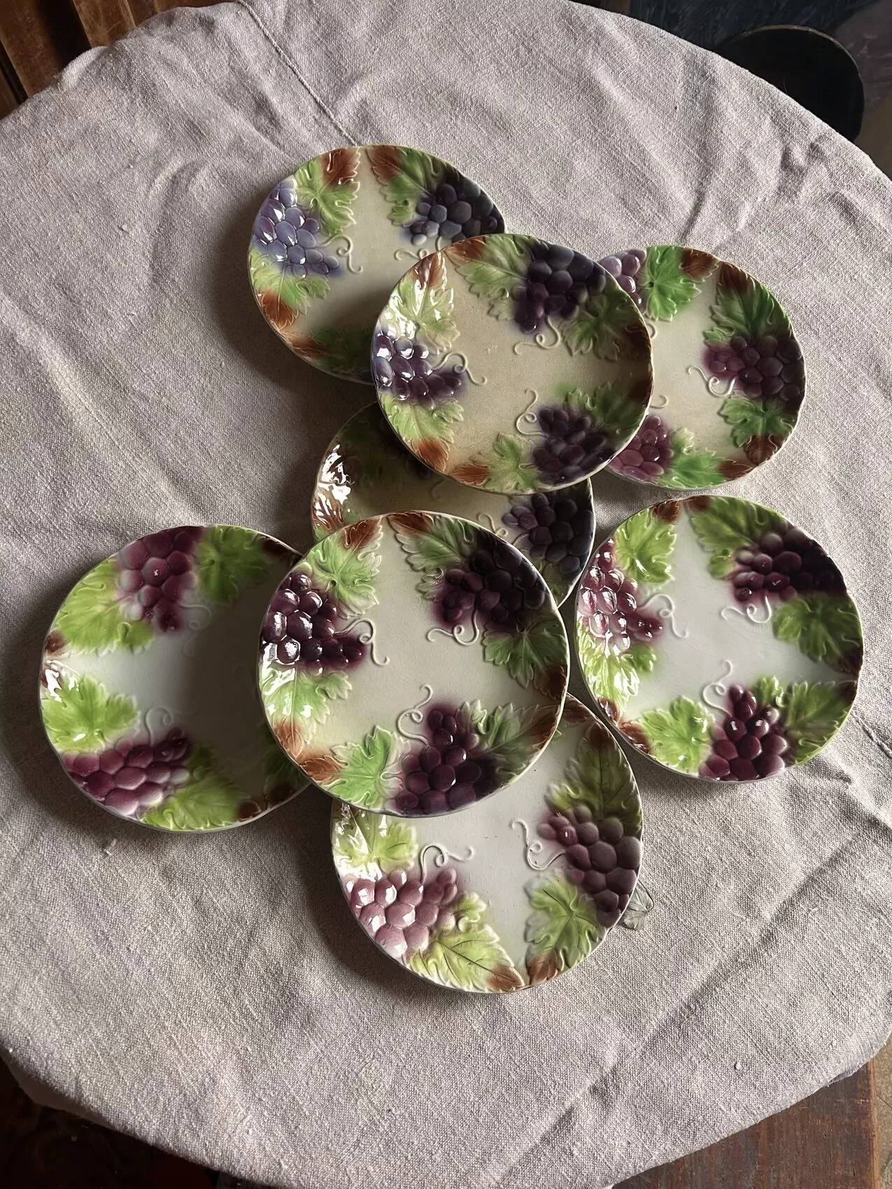Set of eight flat dessert plates in barbotine earthenware with grape decoration – circa 1900.