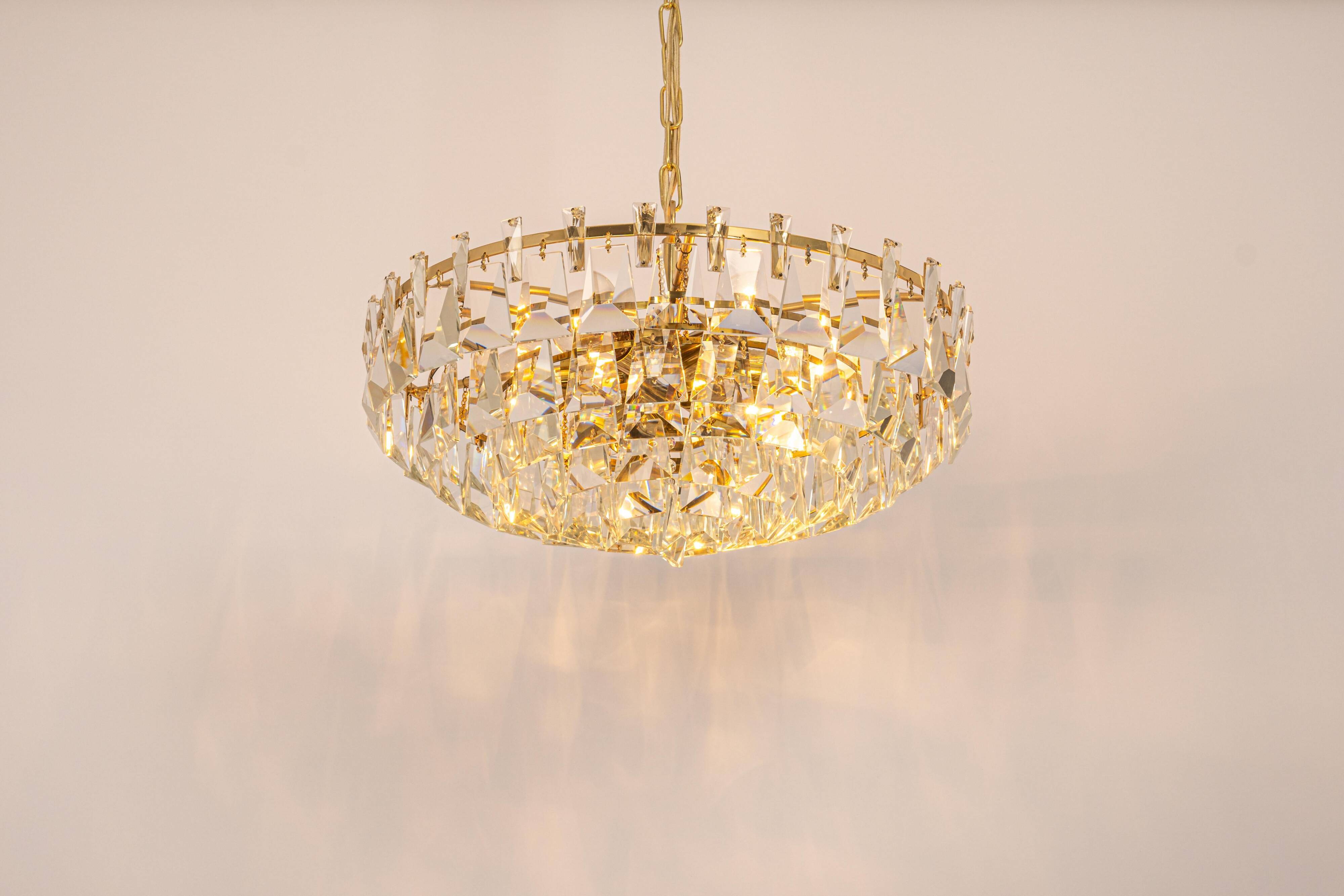 Large chandelier in gilded brass and crystal, by Palwa, Germany, 1970s.