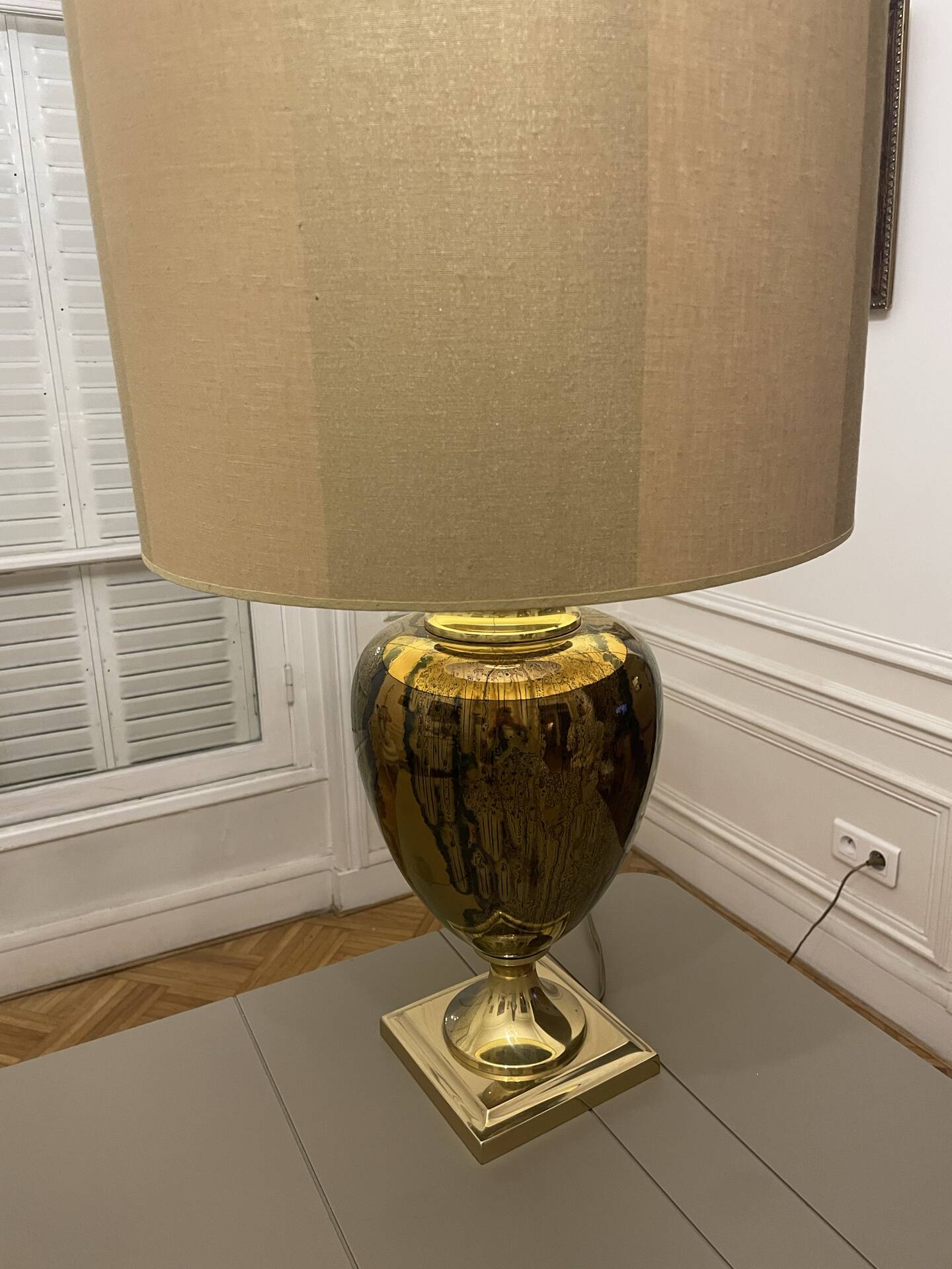 Bronze table lamp with a golden shade.