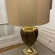 Bronze table lamp with a golden shade.