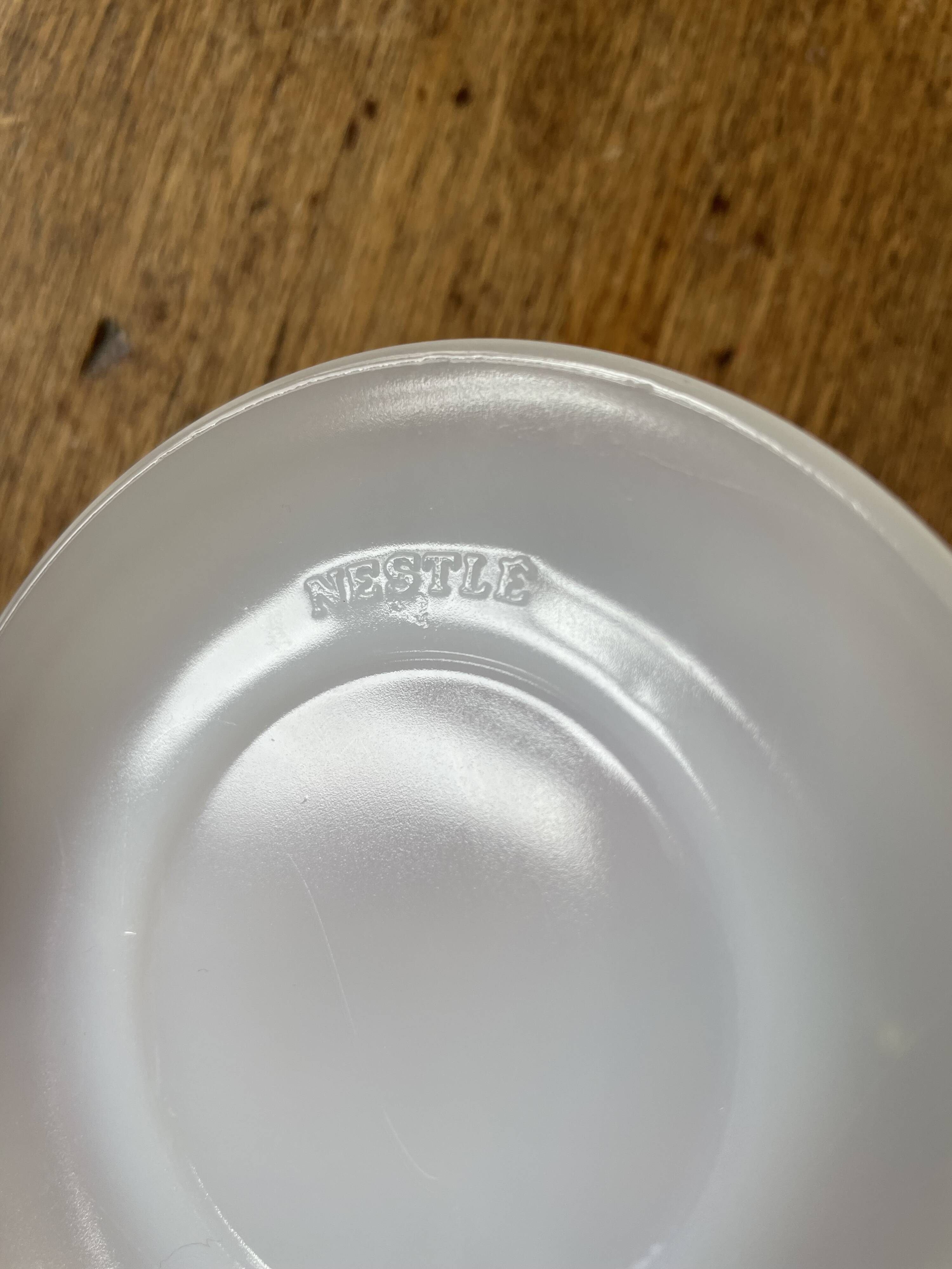 Espresso coffee cup service, Nestlé promotional items, in white glass.