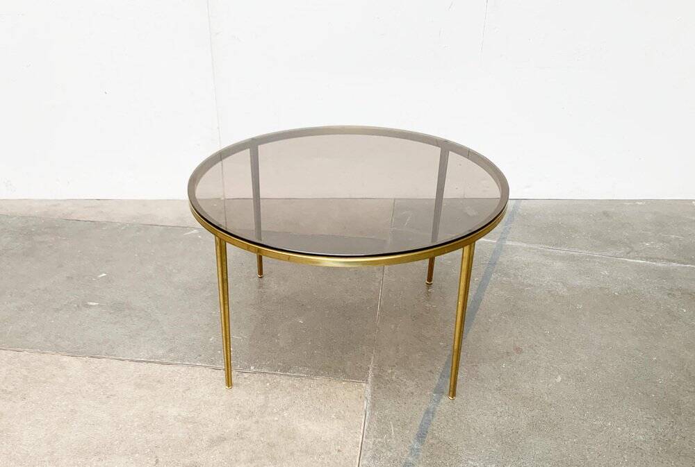 Mid-century Hollywood Regency style coffee table in brass and glass, made in Germany by Vereinigte Werkstätten, 1960s.
